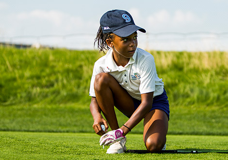 young golfer teeing up a ball